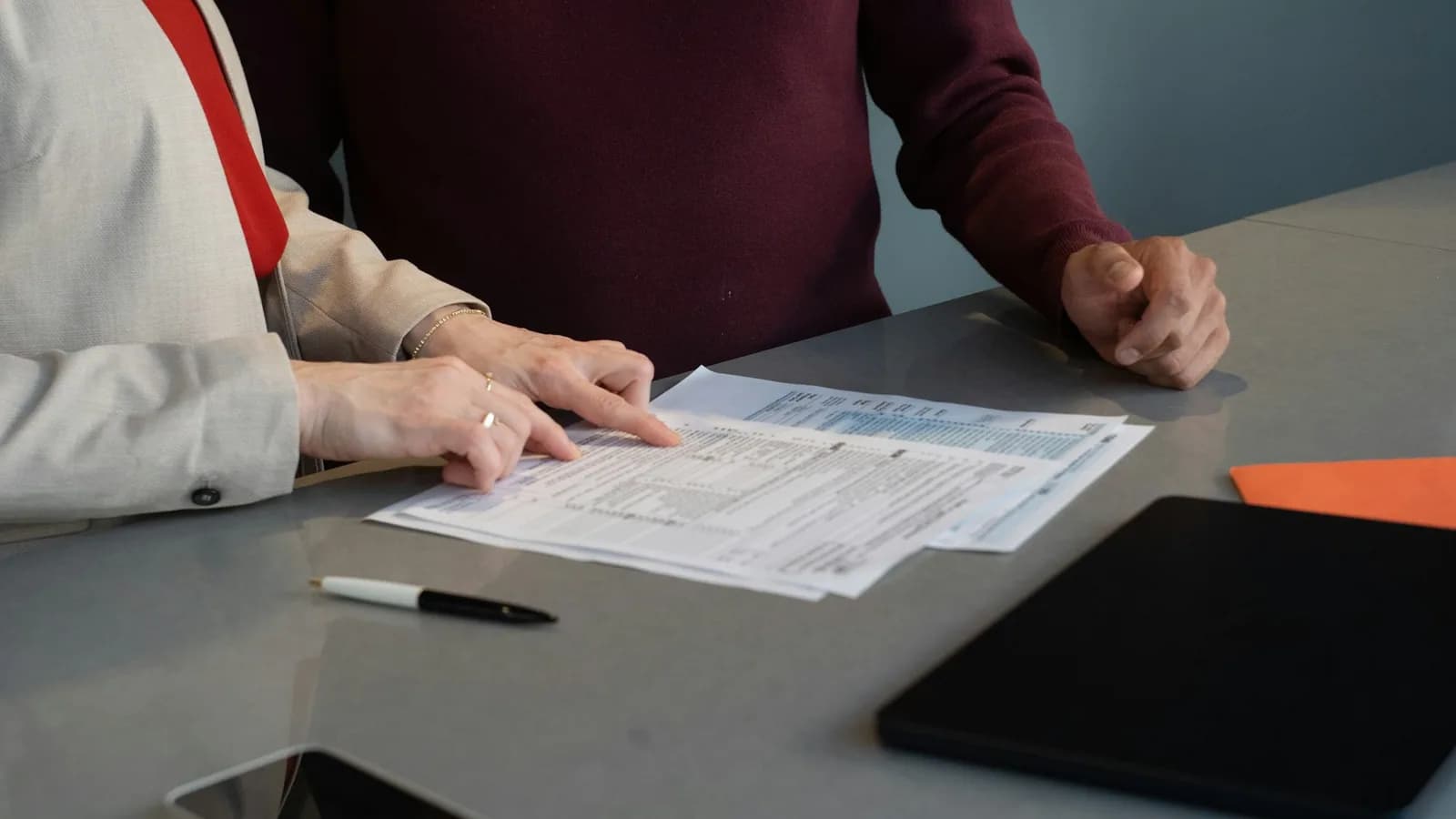 Two people reviewing paperwork at a table