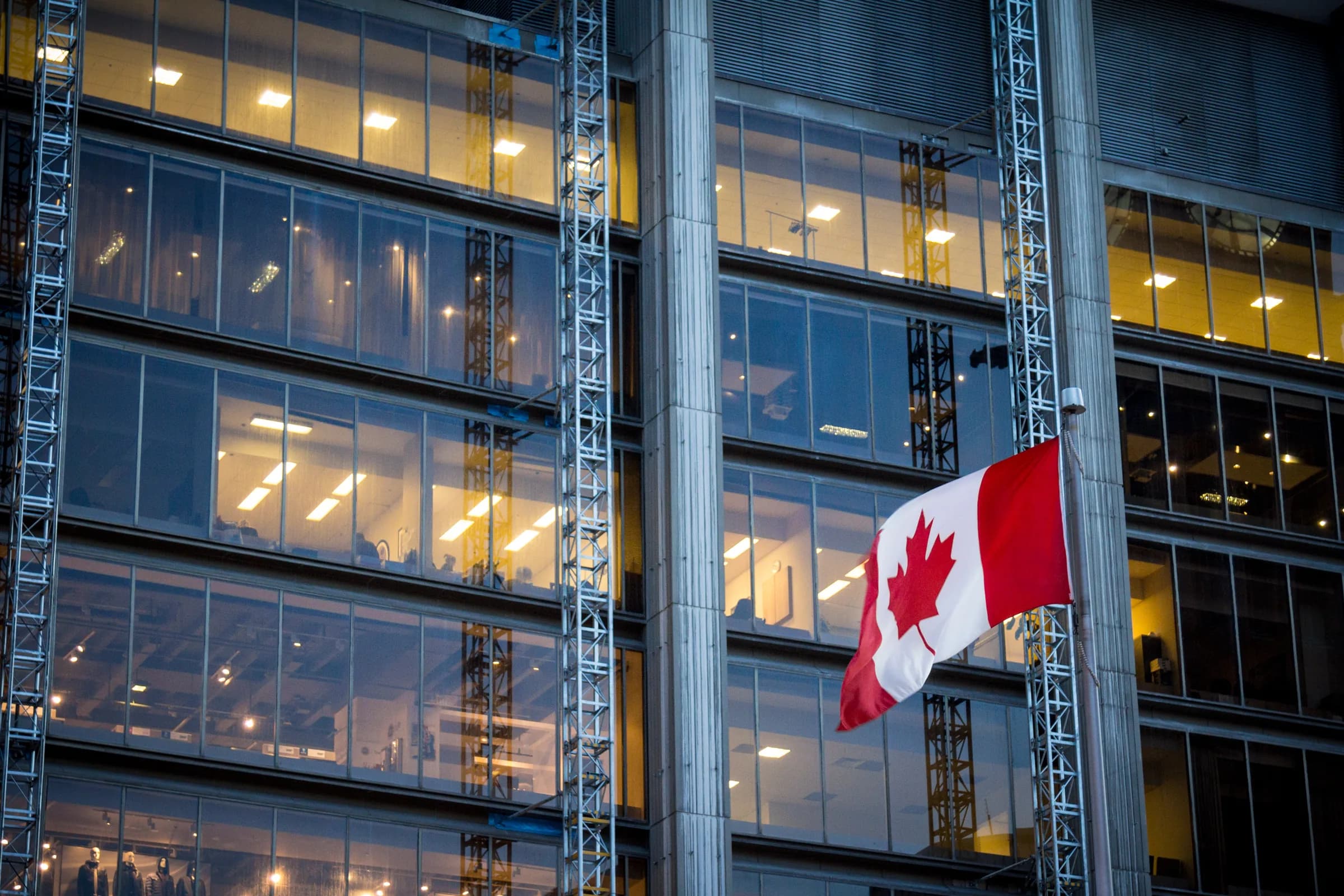 Canadian flag outside a modern office building