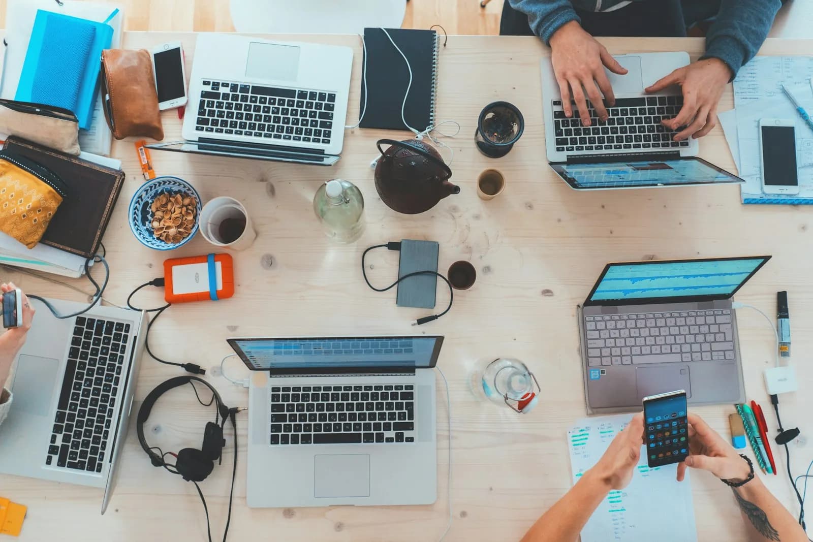 Professionals collaborating at laptops in a modern office